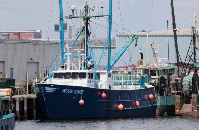 The Blue Wave fishing boat returns to the dock in front of the Blue Harvest Fisheries in New Bedford.