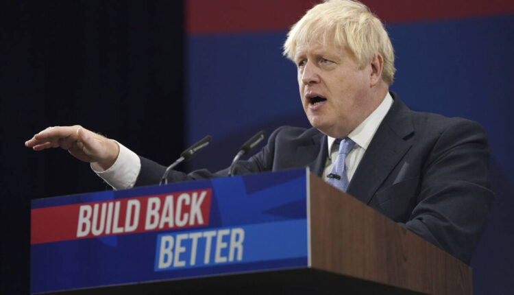 Britain's Prime Minister Boris Johnson gestures as he makes his keynote speech at the Conservative party conference in Manchester, England, Wednesday, Oct. 6, 2021. (AP Photo/Jon Super)
