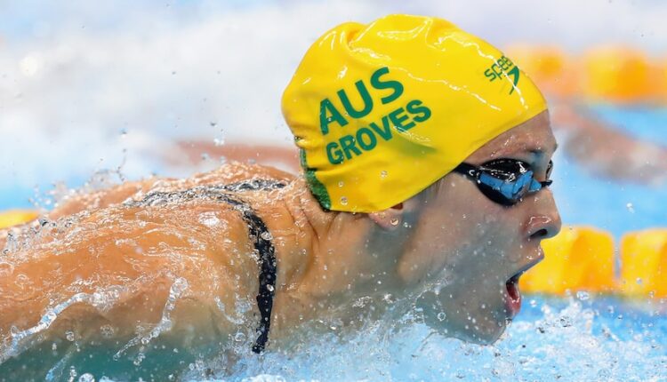 Female swimmer coming up for a breath while completing in an event 
